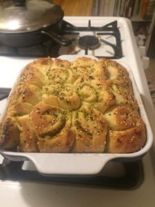 Garlicky dinner rolls in a square pan